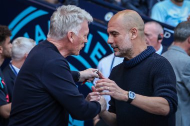 Pep Guardiola manager of Manchester City meets with David Moyes manager of West Ham United right before kick off during the Premier League match Manchester City vs West Ham United at Etihad Stadium, Manchester, United Kingdom, 19th May 2024 