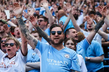 Man City supporters cheer on their team during the Premier League match Manchester City vs West Ham United at Etihad Stadium, Manchester, United Kingdom, 19th May 2024 