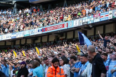 Man City supporters cheer on their team during the Premier League match Manchester City vs West Ham United at Etihad Stadium, Manchester, United Kingdom, 19th May 2024 