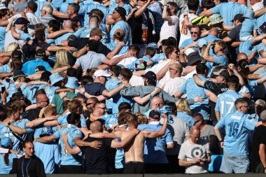 Man City supporters turn their backs and cheer on their team during the Premier League match Manchester City vs West Ham United at Etihad Stadium, Manchester, United Kingdom, 19th May 2024