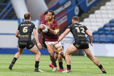 Leroy Cudjoe of Huddersfield Giants looks to pass Matt Moylan of Leigh Leopards during the Betfred Super League Round 12 match Huddersfield Giants vs Leigh Leopards at John Smith's Stadium, Huddersfield, United Kingdom, 24th May 2024  clipart