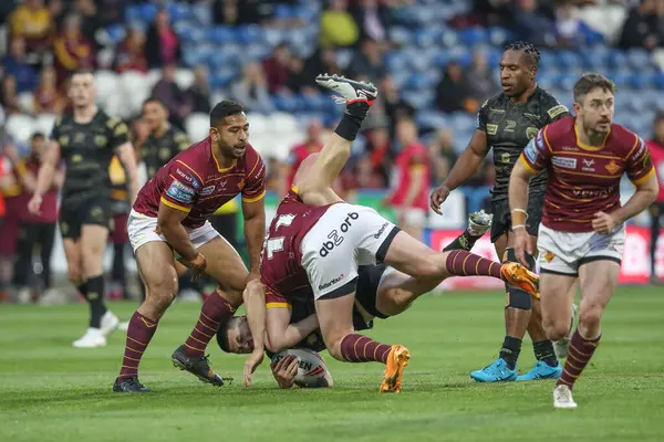 stock image Dan Norman of Leigh Leopards is tackled by Jack Murchie of Huddersfield Giants during the Betfred Super League Round 12 match Huddersfield Giants vs Leigh Leopards at John Smith's Stadium, Huddersfield, United Kingdom, 24th May 2024 