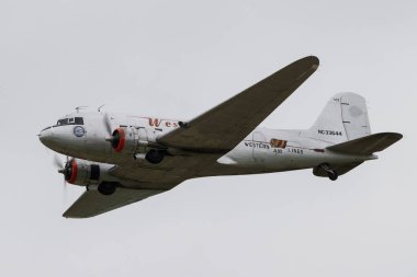 DC-3 Western Air passes over, during the Duxford Summer Air Show: D-Day 80 at IWM Duxford, Duxford, United Kingdom, 1st June 2024 clipart