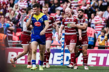 Wigan Warriors takımından Liam Farrell, 8 Haziran 2024 'te Wembley Stadyumu, Londra' da oynanan Betfred Challenge Cup final maçında takım arkadaşlarıyla denemesini kutluyor. 