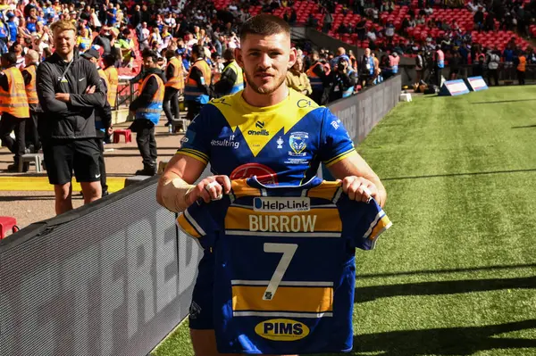 stock image Danny Walker of Warrington Wolves holds up a shirt in memory of Rob Burrow CBE after the Betfred Challenge Cup Final match Warrington Wolves vs Wigan Warriors at Wembley Stadium, London, United Kingdom, 8th June 2024 