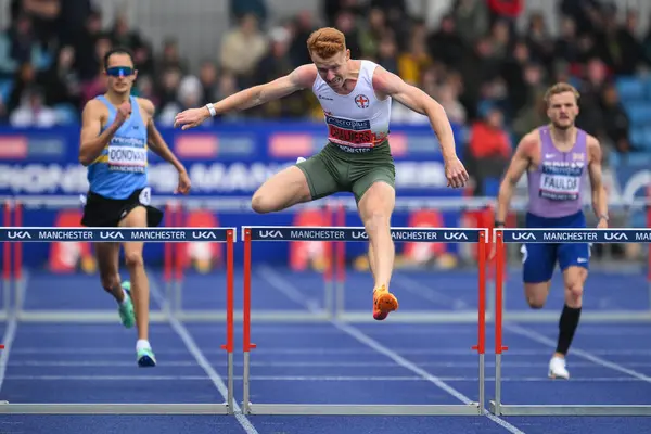 stock image Alastair Chalmers clears the final hurdle in the lead in 400m hurdles during the Microplus UK Athletics Championships Day 2 at Manchester Regional Arena, Manchester, United Kingdom, 30th June 2024 