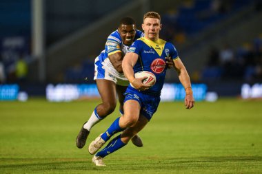 George Williams of Warrington Wolvesis tackled by  Samuel Eseh of Leeds Rhinos during the Betfred Super League Round 17 match Warrington Wolves vs Leeds Rhinos at Halliwell Jones Stadium, Warrington, United Kingdom, 11th July 2024  clipart