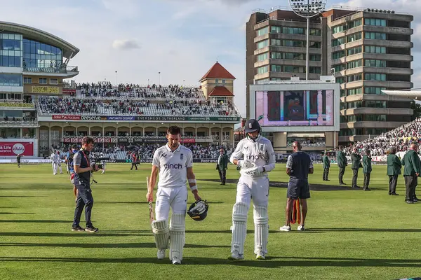 stock image Mark Wood of England and Shoaib Bashir of England leave the field of play after England are all out during the 2nd Rothesay Test Match match England vs West Indies at Trent Bridge, Nottingham, United Kingdom, 18th July 2024 