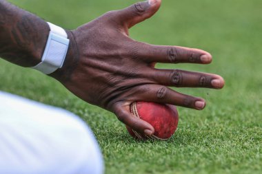 Alzarri Joseph of West Indies stops a ball off Joe Root of England from going to the boundary during the Rothesay Test Match day four match England vs West Indies at Trent Bridge, Nottingham, United Kingdom, 21st July 2024 clipart