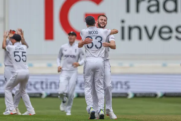 stock image Mark Wood of England and Gus Atkinson of England celebrates the wicket of Kevin Sinclair of West Indies during the Rothesay Test Match day three England vs West Indies at Trent Bridge, Nottingham, United Kingdom, 20th July 2024