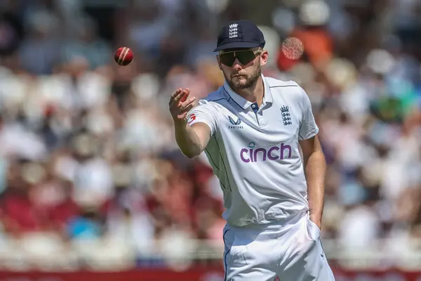 stock image Gus Atkinson of England passes the ball during the 2nd Rothesay Test Match day two England v West Indies at Trent Bridge, Nottingham, United Kingdom, 19th July 2024