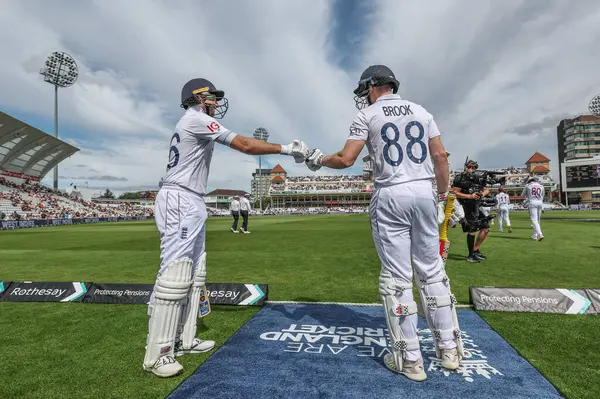 stock image Joe Root of England and Harry Brook of England bump fists before they go out to bat during the Rothesay Test Match day four match England vs West Indies at Trent Bridge, Nottingham, United Kingdom, 21st July 2024