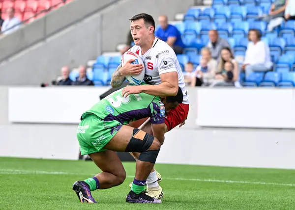 stock image Deon Cross of Salford Red Devils gets tackled during the Betfred Super League Round 19 match Salford Red Devils vs Castleford Tigers at Salford Community Stadium, Eccles, United Kingdom, 27th July 2024