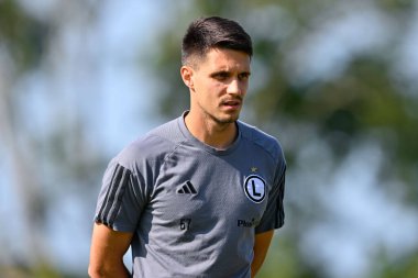 Bartosz Kapustka of Legia Warszawa inspects the pitch ahead of the UEFA Europa Conference League Second Qualifying Round 2nd leg match Caernarfon Town vs Legia Warsaw at Nantporth, Bangor, United Kingdom, 1st August 2024 clipart