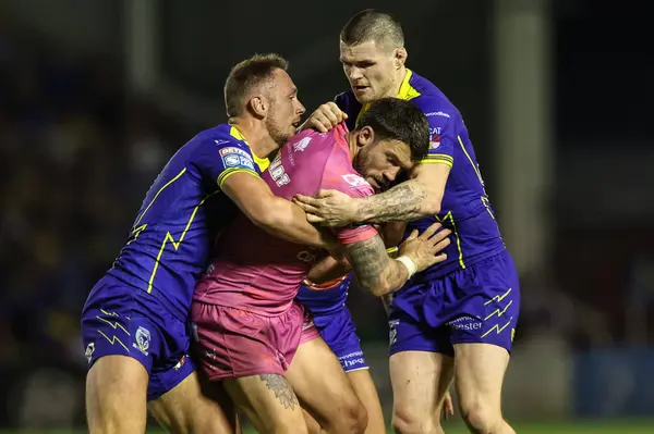 stock image Oliver Gildart tackled by Ben Currie of Warrington Wolves and John Bateman of Warrington Wolves during the Betfred Super League Round 20 match Warrington Wolves vs Hull KR at Halliwell Jones Stadium, Warrington, United Kingdom, 2nd August 2024