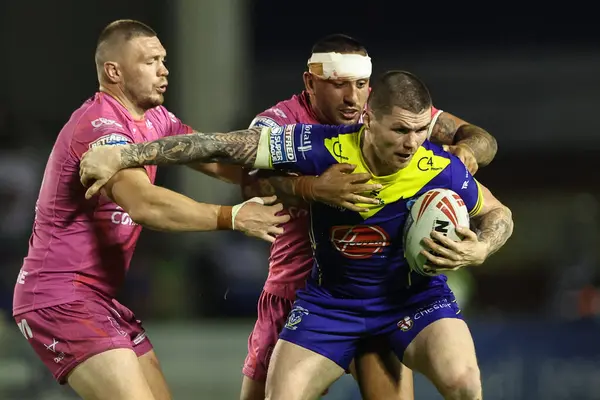 stock image John Bateman of Warrington Wolves is tackled by Elliot Minchella of Hull KR during the Betfred Super League Round 20 match Warrington Wolves vs Hull KR at Halliwell Jones Stadium, Warrington, United Kingdom, 2nd August 2024