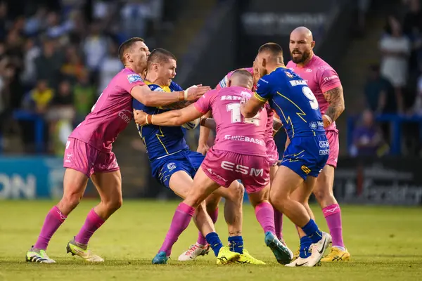 stock image John Bateman of Warrington Wolves is tackled by Matt Parcell of Hull KR and James Batchelor of Hull KR during the Betfred Super League Round 20 match Warrington Wolves vs Hull KR at Halliwell Jones Stadium, Warrington, United Kingdom, 2nd August 202