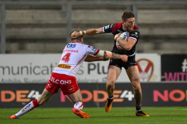 Ethan Ryan of Salford Red Devils breaks the tackle of Mark Percival of St. Helens  during the Betfred Super League Round 21 match St Helens vs Salford Red Devils at Totally Wicked Stadium, St Helens, United Kingdom, 8th August 2024 clipart