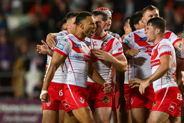 stock image Moses Mbye of St. Helens celebrates his drop goal in extra time to win Betfred Super League Round 21 match St Helens vs Salford Red Devils at Totally Wicked Stadium, St Helens, United Kingdom, 8th August 2024