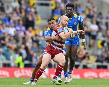 Liam Marshall of Wigan Warriors is tackled by Sam Lisone of Leeds Rhinos during the Betfred Super League Round 21 match Leeds Rhinos vs Wigan Warriors at Headingley Stadium, Leeds, United Kingdom, 10th August 2024 clipart