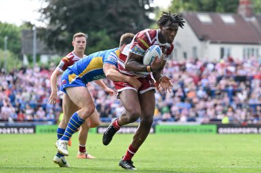 Junior Nsemba of Wigan Warriors gets tackled during the Betfred Super League Round 21 match Leeds Rhinos vs Wigan Warriors at Headingley Stadium, Leeds, United Kingdom, 10th August 2024 clipart