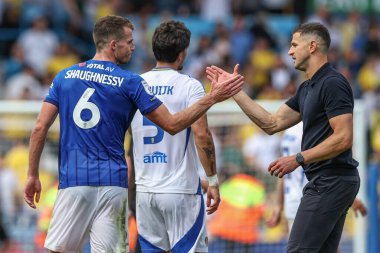 Conor Shaughnessy of Portsmouth shakes hands with John Mousinho manager of Portsmouth after the game during the Sky Bet Championship match Leeds United vs Portsmouth at Elland Road, Leeds, United Kingdom, 10th August 2024 clipart