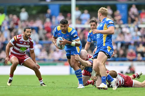 stock image Rhyse Martin of Leeds Rhinos gets tackled during the Betfred Super League Round 21 match Leeds Rhinos vs Wigan Warriors at Headingley Stadium, Leeds, United Kingdom, 10th August 2024