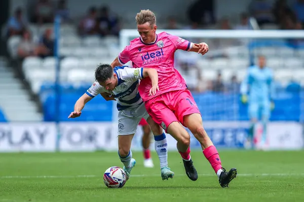 stock image Paul Smyth of Queens Park Rangers battles for the ball Torbjoan Heggem of West Bromwich Albion during the Sky Bet Championship match Queens Park Rangers vs West Bromwich Albion at Kiyan Prince Foundation Stadium, London, United Kingdom