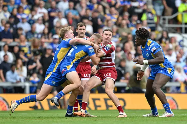 stock image Jai Field of Wigan Warriors gets tackled during the Betfred Super League Round 21 match Leeds Rhinos vs Wigan Warriors at Headingley Stadium, Leeds, United Kingdom, 10th August 2024