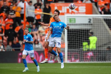 Matthew Pennington of Blackpool and Will Collar of Stockport County battle for the ball during the Sky Bet League 1 match Blackpool vs Stockport County at Bloomfield Road, Blackpool, United Kingdom, 17th August 2024 clipart