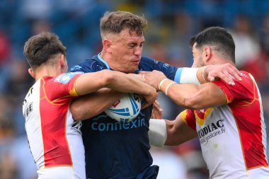 Jai Whitbread of Hull KR is tackled by Arthur Mourgue of Catalan Dragons and Ben Garcia of Catalan Dragons during the Magic Weekend match Catalans Dragons vs Hull KR at Elland Road, Leeds, United Kingdom, 18th August 2024 clipart