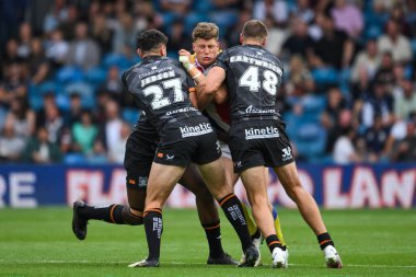 Rhys Kennedy of London Broncos is tackled by Zach Jebson Hull FC and Jed Cartwright of Hull FC during the Magic Weekend match Hull FC vs London Broncos at Elland Road, Leeds, United Kingdom, 17th August 2024 clipart