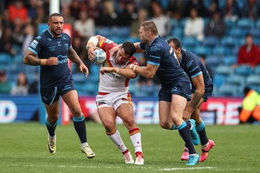 Ben Garcia of Catalan Dragons is tackled by James Batchelor of Hull KR during the Magic Weekend match Catalans Dragons vs Hull KR at Elland Road, Leeds, United Kingdom, 18th August 2024 clipart