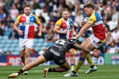 Rhys Kennedy of London Broncos is tackled by Ligi Sao Hull FC during the Magic Weekend match Hull FC vs London Broncos at Elland Road, Leeds, United Kingdom, 17th August 2024 clipart