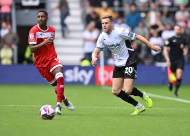 Isaiah Jones of Middlesbrough crosses the ball with Callum ELDER of Derby County FC in defence during the Sky Bet Championship match Derby County vs Middlesbrough at Pride Park Stadium, Derby, United Kingdom, 17th August 2024 clipart