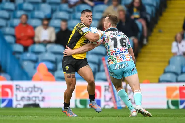 stock image Jayden Nikorima of Salford Red Devils breaks the tackle of Frankie Halton of Leigh Leopards during the Magic Weekend match Leigh Leopards vs Salford Red Devils at Elland Road, Leeds, United Kingdom, 18th August 2024