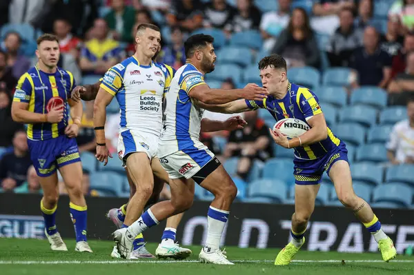 stock image Josh Thewlis of Warrington Wolves hands off Rhyse Martin of Leeds Rhinos during the Magic Weekend match Warrington Wolves vs Leeds Rhinos at Elland Road, Leeds, United Kingdom, 17th August 2024