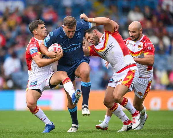 stock image Jai Whitbread of Hull KR is tackled by Arthur Mourgue of Catalan Dragons and Ben Garcia of Catalan Dragons during the Magic Weekend match Catalans Dragons vs Hull KR at Elland Road, Leeds, United Kingdom, 18th August 2024