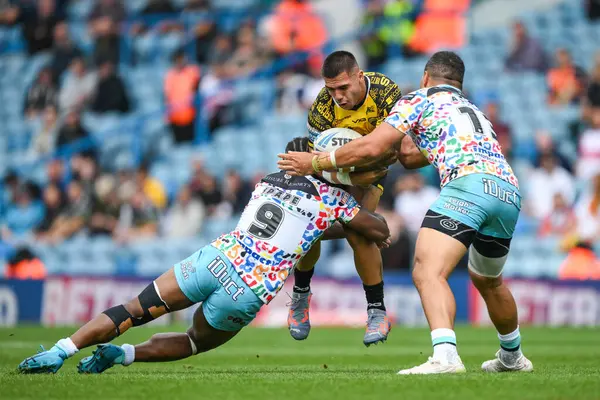 stock image Jayden Nikorima of Salford Red Devils is tackled by Edwin Ipape of Leigh Leopards and John Asiata of Leigh Leopards during the Magic Weekend match Leigh Leopards vs Salford Red Devils at Elland Road, Leeds, United Kingdom, 18th August 2024