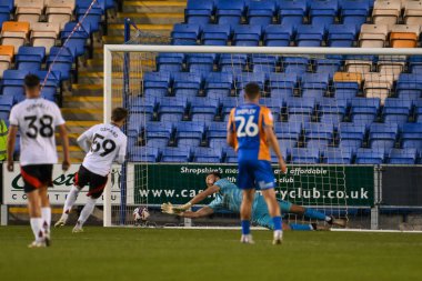 Toby Savin of Shrewsbury Town saves the penalty of Callumn Osmond of Fulham FC during the Bristol Street Motors Trophy match Shrewsbury Town vs Fulham U21 at Croud Meadow, Shrewsbury, United Kingdom, 20th August 2024 clipart