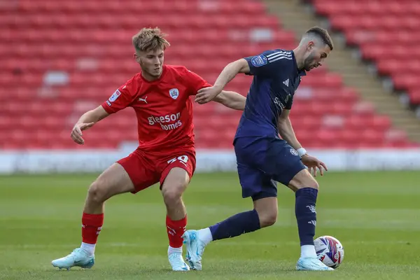 Stock image Jonathan Bland of Barnsley and Ruben Curley of Manchester United battle for the ball during the Bristol Street Motors Trophy match Barnsley vs Manchester United U21 at Oakwell, Barnsley, United Kingdom, 20th August 2024