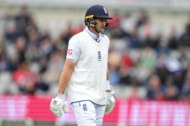 Joe Root of England leaves the pitch after being caught out by Dinesh Chandimal of Sri Lanka during the England Men v Sri Lanka 1st Rothesay Test Match Day 2 at Old Trafford, Manchester, United Kingdom, 22nd August 2024 clipart