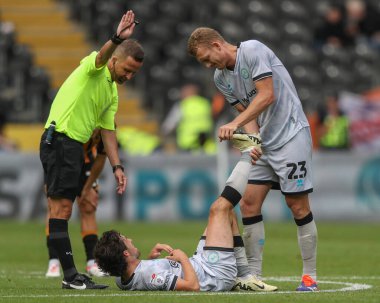 George Saville of Millwall helps his teammate George Honeyman of Millwall during the Sky Bet Championship match Hull City vs Millwall at MKM Stadium, Hull, United Kingdom, 24th August 2024 clipart