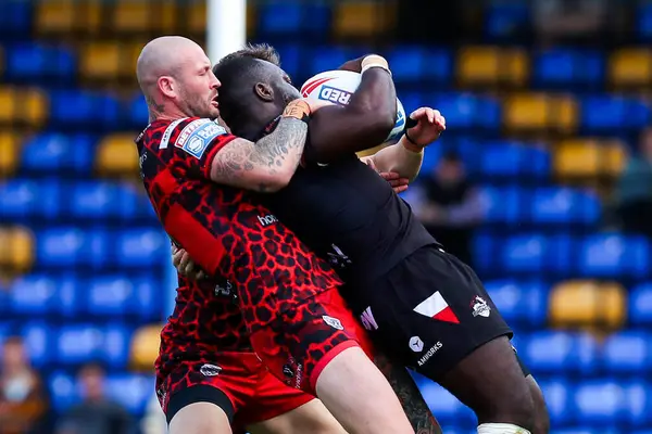 stock image Zak Hardaker of Leigh Leopards tackles Sadiq Adebiyi of London Broncos during the Betfred Super League Round 23 match London Broncos vs Leigh Leopards at Plough Lane, Wimbledon, United Kingdom, 25th August 2024