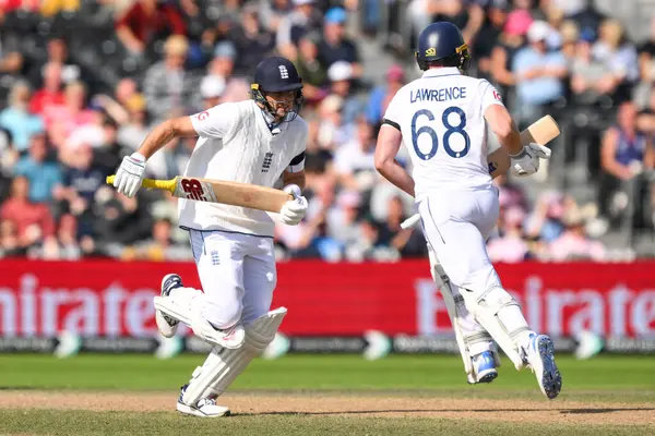 stock image Joe Root of England and Dan Lawrence of England run for a single during the England Men v Sri Lanka 1st Rothesay Test Match Day 4 at Old Trafford, Manchester, United Kingdom, 24th August 2024