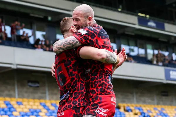 stock image Frankie Halton of Leigh Leopards celebrates his try with Zak Hardaker during the Betfred Super League Round 23 match London Broncos vs Leigh Leopards at Plough Lane, Wimbledon, United Kingdom, 25th August 2024