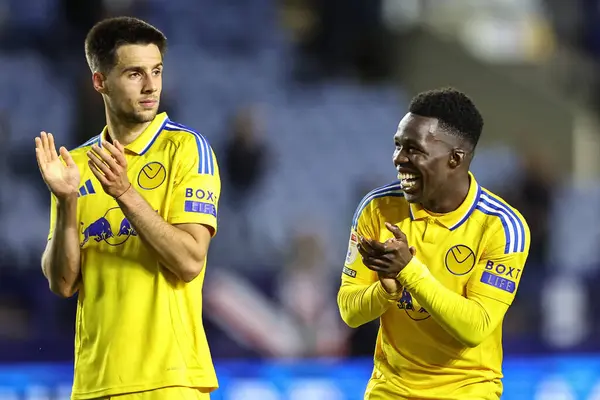 stock image Ilia Gruev of Leeds United and Wilfried Gnonto of Leeds United applaud the travelling fans during the Sky Bet Championship match Sheffield Wednesday vs Leeds United at Hillsborough, Sheffield, United Kingdom, 23rd August 2024