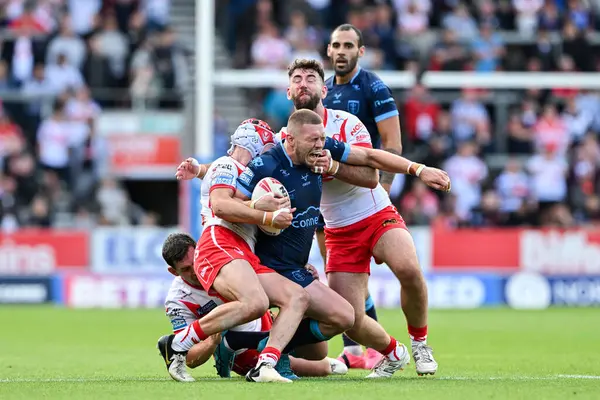 Stock image James Batchelor of Hull KR gets tackled during the Betfred Super League Round 23 match St Helens vs Hull KR at Totally Wicked Stadium, St Helens, United Kingdom, 24th August 2024