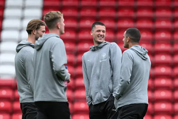 stock image Oliver Casey of Blackpool shares a joke as he arrives ahead of the Carabao Cup match Blackburn Rovers vs Blackpool at Ewood Park, Blackburn, United Kingdom, 27th August 2024