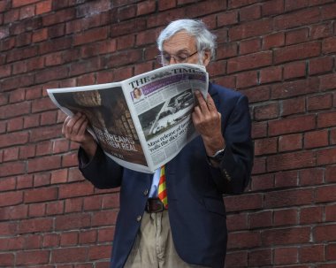 A Marylebone Cricket Club member reads The Times as he waits for the gates to open during the England v Sri Lanka 2nd Rothesay Test Match Day 1 at Lords, London, United Kingdom, 29th August 2024 clipart